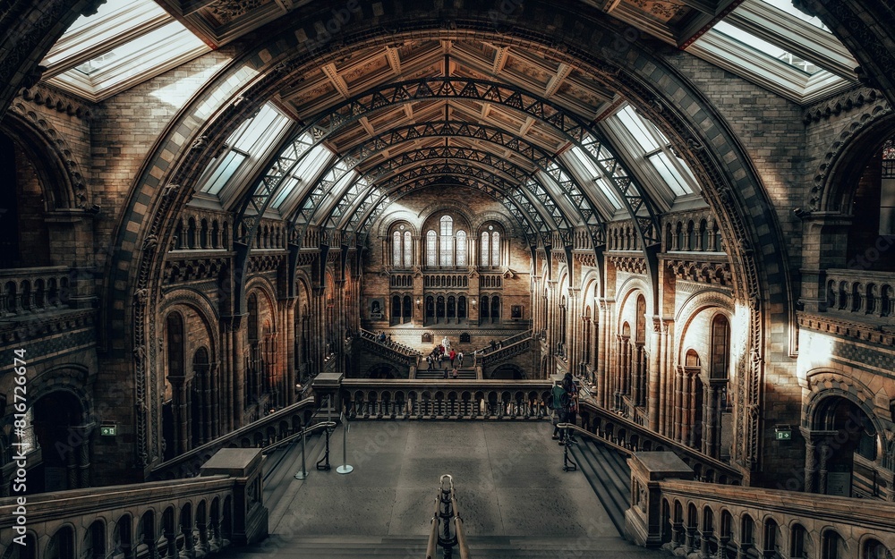 an inside shot of a museum with a man standing on the stairs an inside shot of a museum with a man standing on the stairs