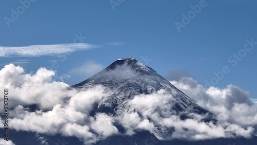 Scenic view of the peak of Osorno volcano mountain touching the clouds in Los Lagos, southern Chile photo