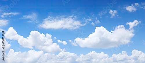 A serene background of a clear blue sky with white clouds. with copy space image. Place for adding text or design