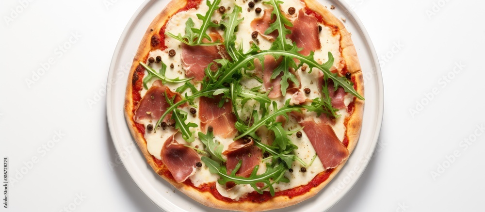 Top view of a pizza with mozzarella salami chicken bacon and fresh arugula salad over a white background There is copy space available Top view of a pizza with mozzarella salami chicken bacon and fresh arugula salad over a white background There is copy space available