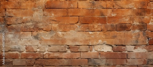The image shows a textured wall made of ancient worn out orange bricks with plenty of empty space for copy