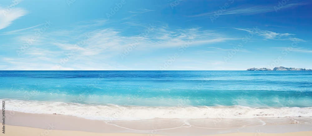 Fototapeta premium Sunny day at the beach with a clear ocean water view against a serene nature background ideal for a copy space image