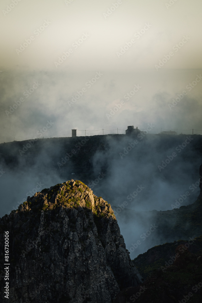 Fototapeta premium Scenic view of mountain peaks in the clouds in Pico Ruivo train in Madeira Island, Portugal