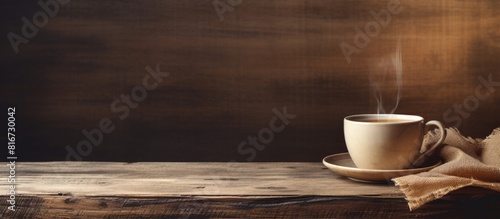 Toned copy space image of a cup of tea placed on a new wooden board with a burlap background