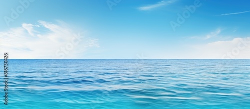 A serene clear sea creates a wide horizontal copy space image perfect for print or web banners with a white room for text The panoramic view offers a calming and relaxing background surface water tex