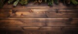 Top view of an old wooden table adorned with pine branches and decorations creating a festive holiday background The image provides ample space for text or design