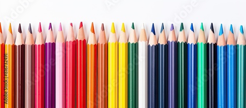 A copy space image of colored pencils against a white backdrop