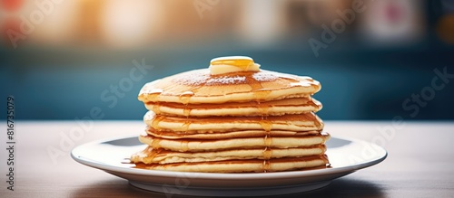 A tall stack of pancakes perfect for a family breakfast with a shallow depth of field and an empty area for additional content © vxnaghiyev
