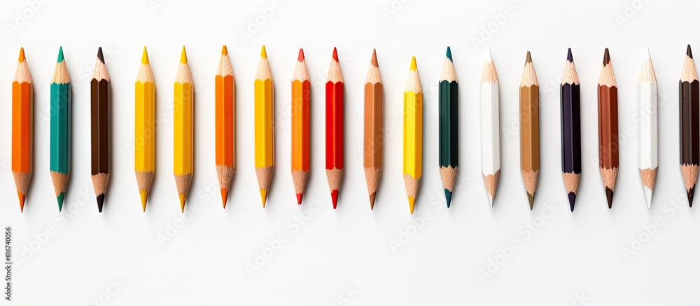 A white background showcases a top down view of 12 pencils providing ample copy space for text A white background showcases a top down view of 12 pencils providing ample copy space for text