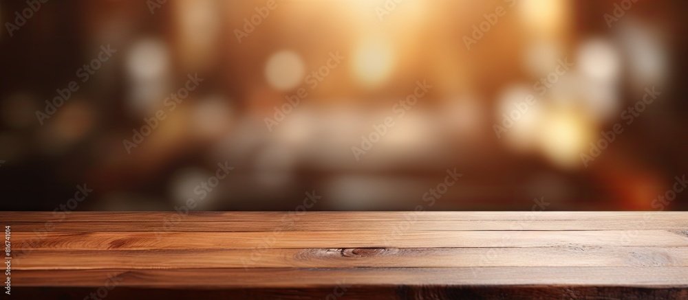In a room with blurred background there is a wood table top that offers empty copy space for various purposes In a room with blurred background there is a wood table top that offers empty copy space for various purposes