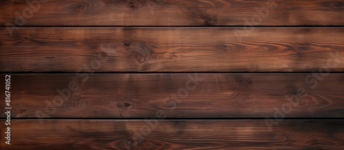 A texture of dark brown wood planks with a lighter area for adding text or images. with copy space image. Place for adding text or design