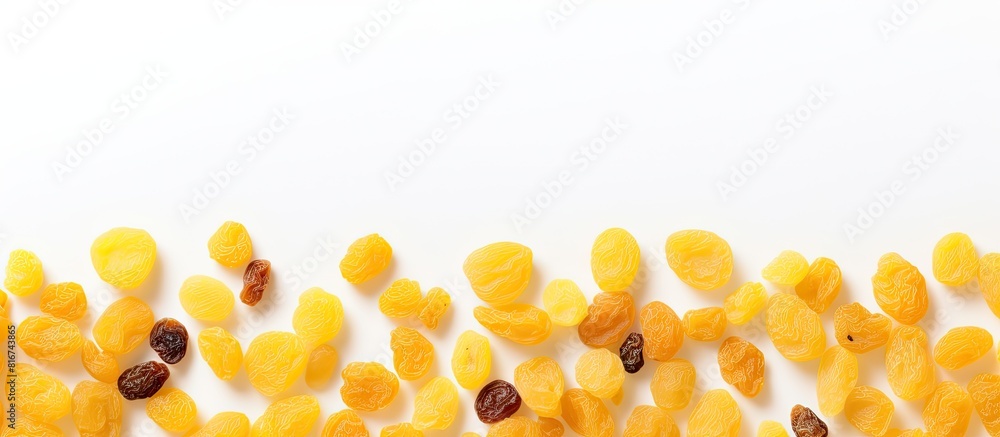 A copy space image of yellow raisins seen from above set against a white background allowing room for text A copy space image of yellow raisins seen from above set against a white background allowing room for text