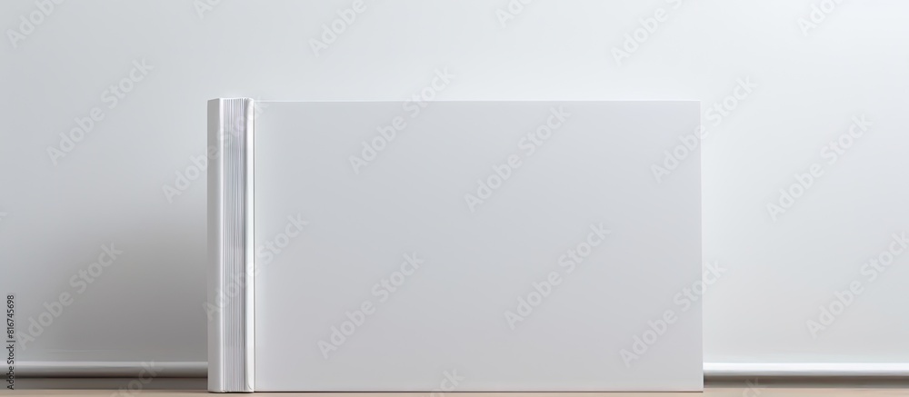 Copy space image of a blank white book resting on a white paper backdrop Copy space image of a blank white book resting on a white paper backdrop