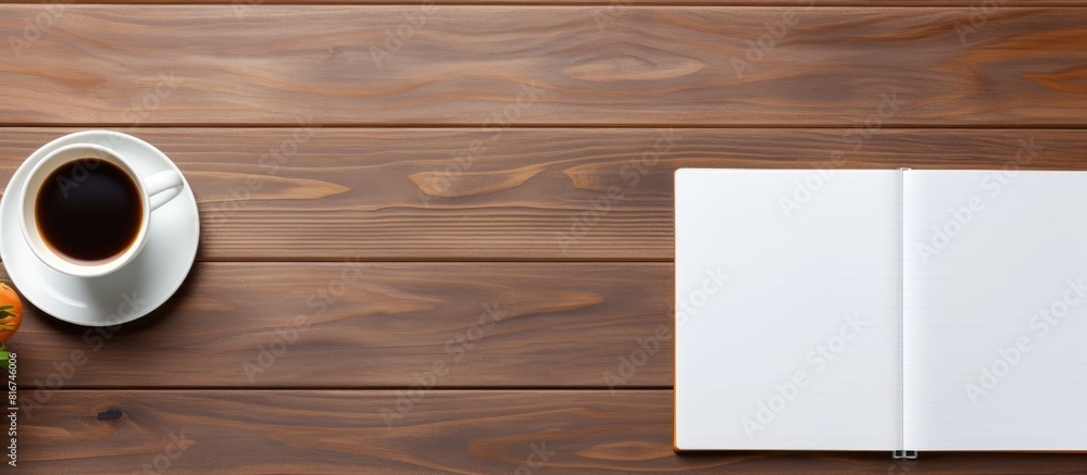A top view of a wooden desk with office supplies including a blank notebook set against a wooden background that offers copy space for images A top view of a wooden desk with office supplies including a blank notebook set against a wooden background that offers copy space for images
