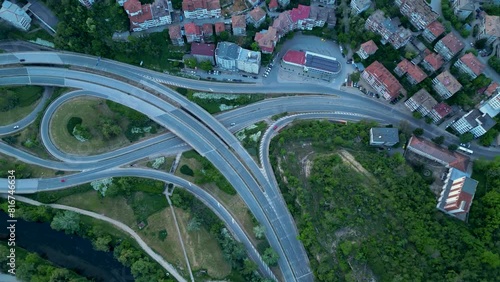 Aerial high angle top down shot of a complicated road network in Veliko Tarnovo. Bulgarian road system confusing and complex seen from above. Drone footage of traffic flowing on multy level roads.
 photo