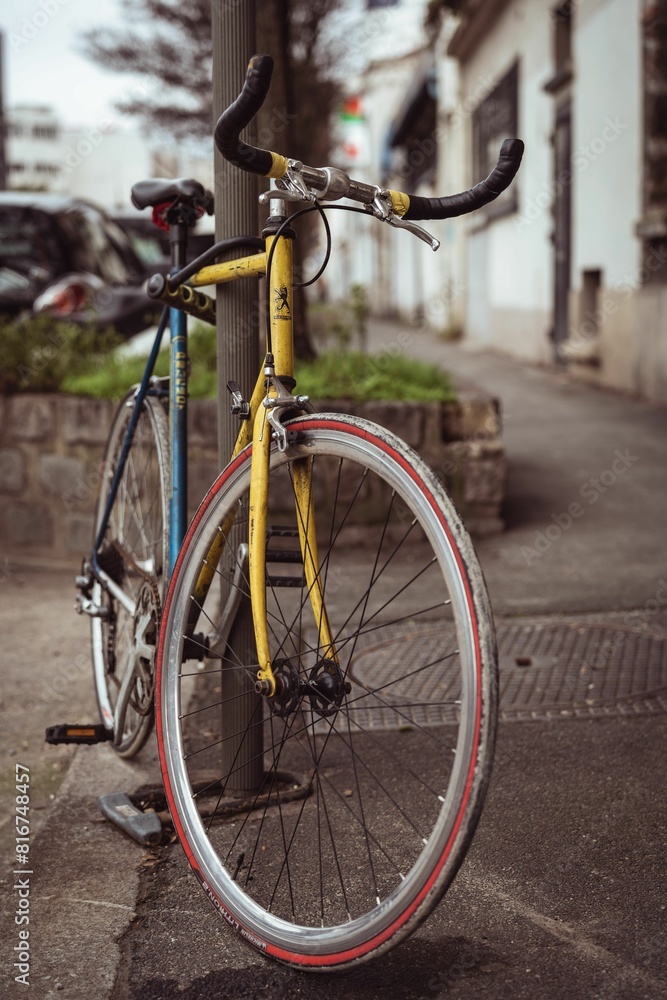 Fototapeta premium Black vintage-style bicycle is parked at the corner of a street