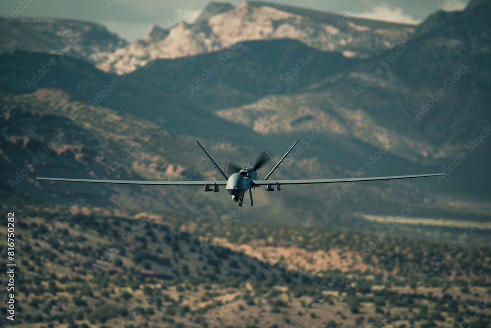 A military drone soars above a rugged mountain range, showcasing its power and agility in the high-altitude environment A military drone soars above a rugged mountain range, showcasing its power and agility in the high-altitude environment