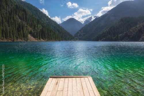 Fototapeta Naklejka Na Ścianę i Meble -  wooden pier on a mountain lake with turquoise clear water. Lake Kolsai or Kulsay in the mountain range of Kazakhstan