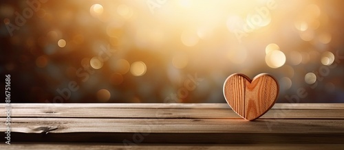 A handcrafted love sign is placed on a wooden table creating a visually appealing composition with copy space image