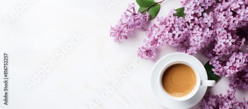 A minimal concept for a wedding or Valentine s Day with a copy space image of a morning breakfast featuring a coffee cup and lilac flowers on a white background