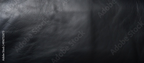 The image displays a black leather texture with ample copy space