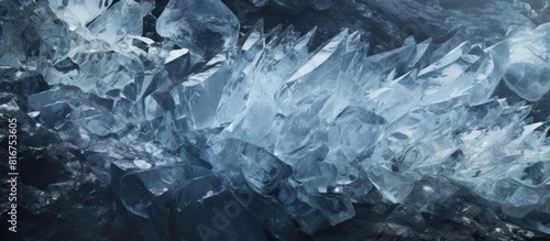 A close up of ice crystals and rocks glistening with frozen water in a copy space image