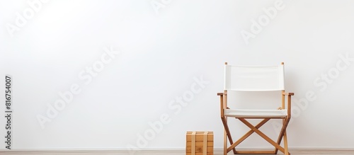 A blank package and white paper shopping bag with handles are placed on a wooden chair against a white background There is empty space available for your logo or design. Copyspace image