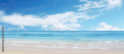 Copy space image of a serene beach with a vivid blue sky in the background