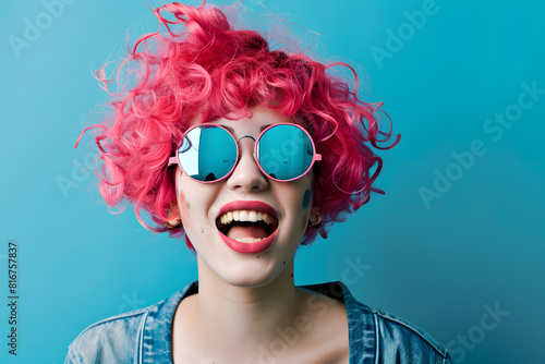 Joyful woman with pink curly hair and sunglasses