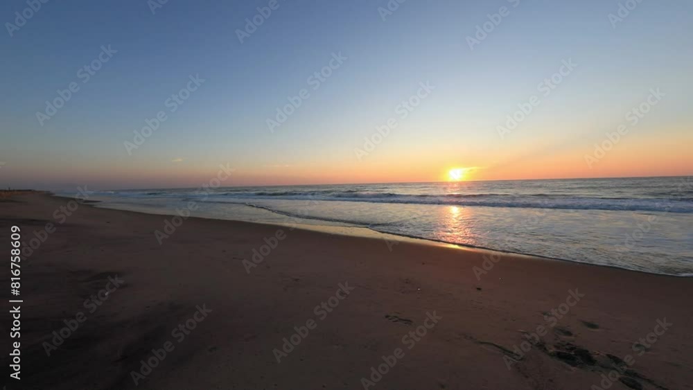 Scenic view as seen from Bethany Beach of the sun rising over the Atlantic Ocean in Delaware, USA Scenic view as seen from Bethany Beach of the sun rising over the Atlantic Ocean in Delaware, USA