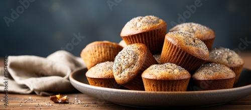 Close up view of healthy gluten free homemmade banana muffins with buckwheat flour Vegan muffins with poppy seeds on blue plate over gray wooden table Copy space photo