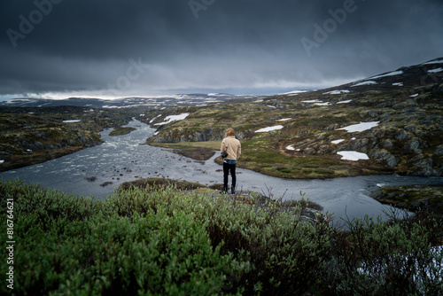 Camera Operator Overlooking Breathtaking Norwegian River System photo