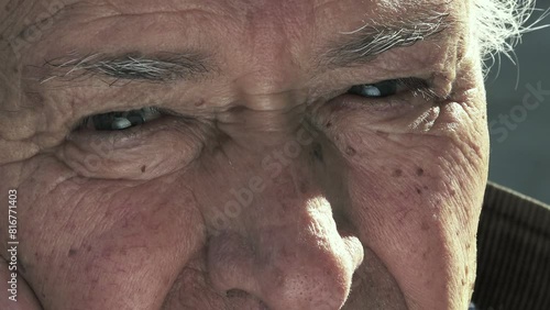 A close-up shot capturing the expressive eyes of an elderly man in his 80s, filled with wisdom and life experiences photo