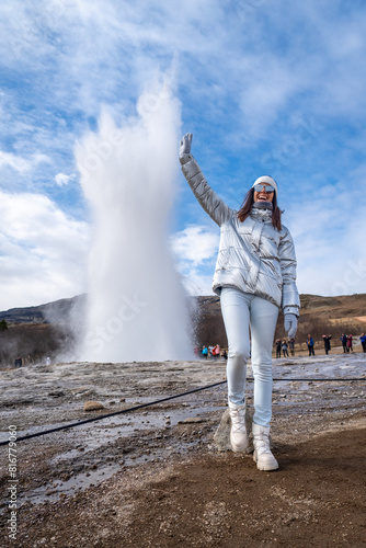 a woman in white standing near a geyse geysen photo