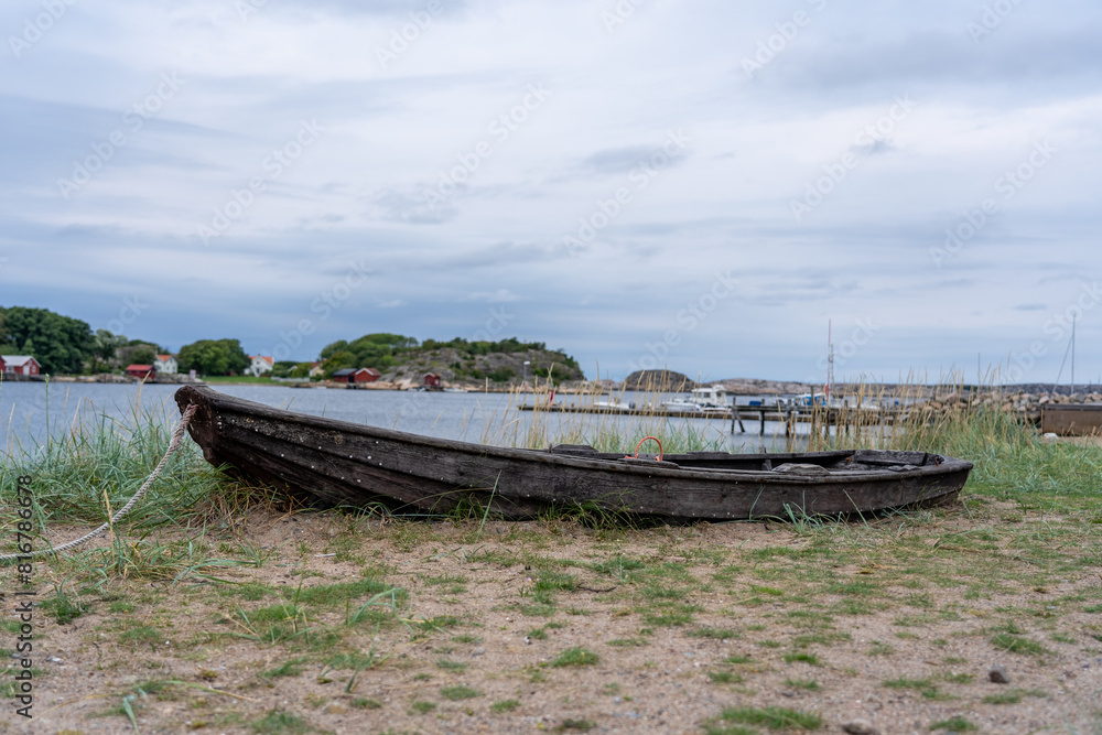 Small vessel rests atop a grassy meadow in Munkkyrkan, Smoegen, Sweden Small vessel rests atop a grassy meadow in Munkkyrkan, Smoegen, Sweden