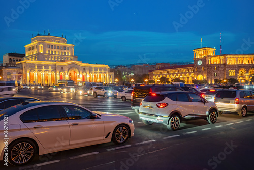 Evening Armenia. City of Yerevan. Republic square. Cars on roads of Armenia. Buildings of national painting gallery. Armenia on summer night. Center of Yerevan with buildings illuminated in evening photo