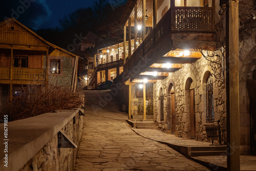 Resorts Armenia. City Dilijan. Residential houses in evening. Ancient architecture Armenia. Buildings from last century illuminated at night. Path paved with stones among houses. Architecture Dilijan photo