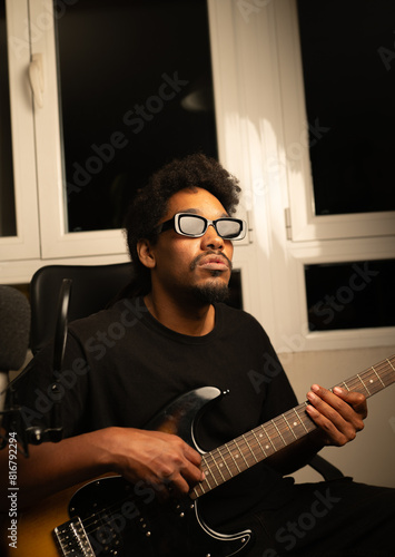 african blind man musician playing guitar recording in production studio