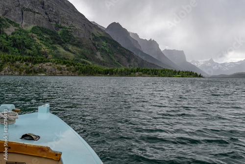 The bow of the boat, bowspirit and rigging, rope, foredeck on St Mary Lake with Citadel Mt. Little Chief Mt.Mahatotopa Mt. visible, Glacier National Park, Montana photo