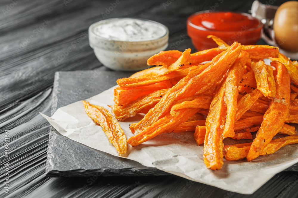 sweet potato fries on a dark wooden rustic background sweet potato fries on a dark wooden rustic background
