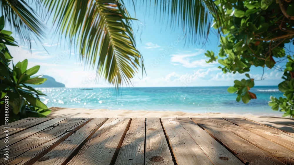 Empty wood table over blue sea, beach and palm leaves background in summer day. Space for product display.