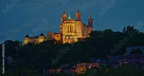 Aerial shot at night time of illuminated Basilica Notre Dame de Fourviere, Lyon, France photo