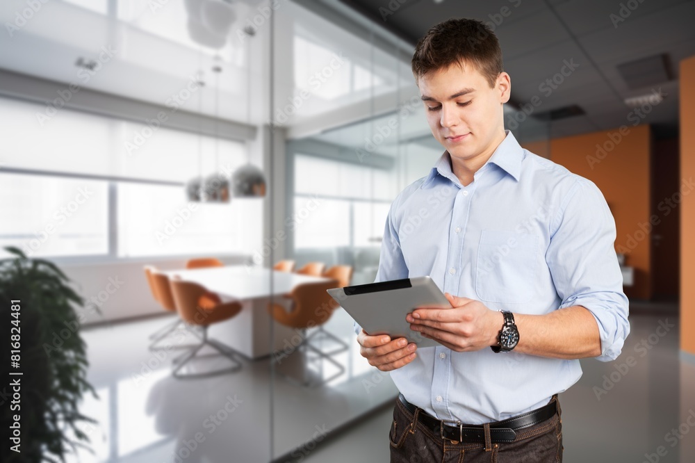 Smiling busy business manager hold tablet computer Smiling busy business manager hold tablet computer