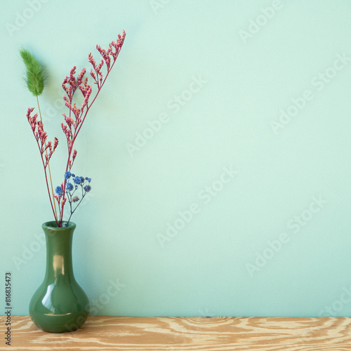 Obraz na płótnie Vase of dry flower on wooden shelf. mint wall background w salonie