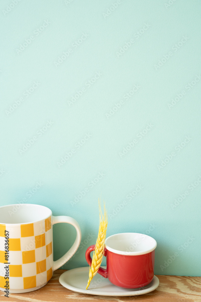 Empty mug cups on wooden shelf. mint wall background