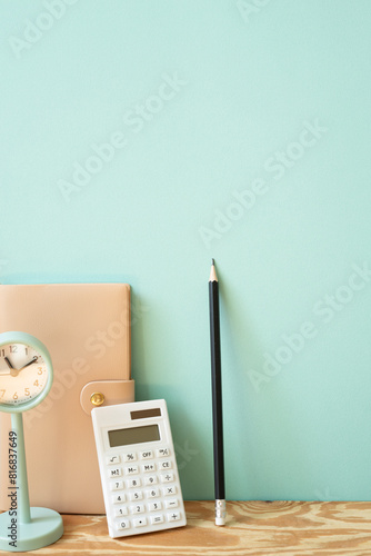 Obraz na płótnie Workspace diary note, calculator, pencil, clock on wooden desk. mint wall background w salonie