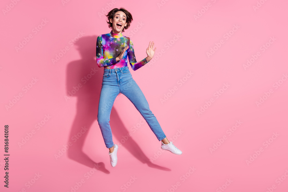 Full body portrait of pretty girl jump empty space wear pullover isolated on pink color background Full body portrait of pretty girl jump empty space wear pullover isolated on pink color background