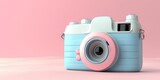 A blue and pink pastel retro camera on a pink background.