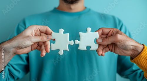 Unknown hands trying to fit puzzle pieces that don't fit. Concept: contrary, against