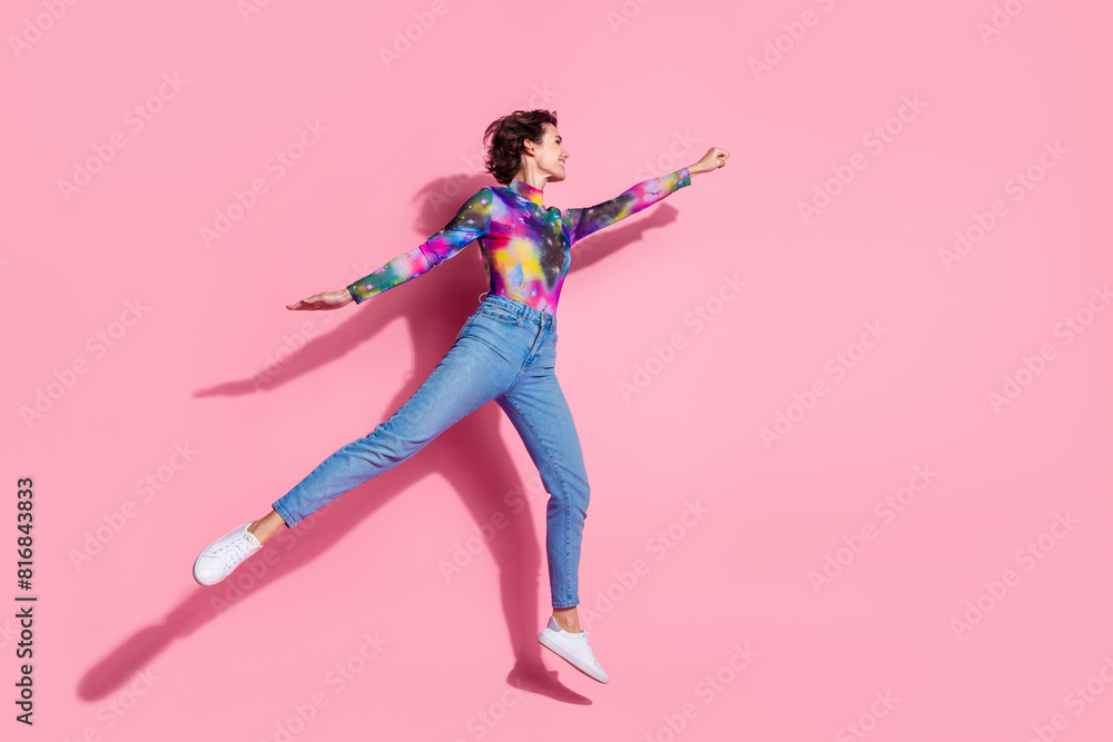 Full body portrait of pretty girl jump fly empty space ad wear pullover isolated on pink color background Full body portrait of pretty girl jump fly empty space ad wear pullover isolated on pink color background